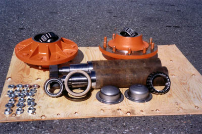 Heavy Duty Hub Assemblies. 20,000 Lb. capacity, oil or grease lubricated. 4 1/2" Dia. Spindle, can be modified to suit your particular requirements or supplied as shown. The spindle is made of high strength material