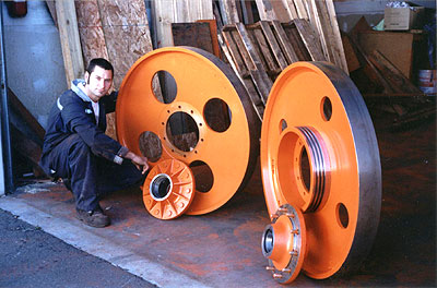 Pair of 44" Dia. x 4 3/8" Face Bandwheels. Driver Wheel has 20" Dia. Sheave machined with the wheel. 20,000 Lb. Hub Assemblies shipped with the wheels. Idler and Driver have approximately 20% weight difference to improve cutting performance